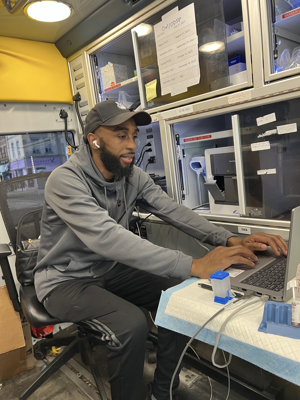 A HepCURE team member providing point-of-care testing inside the mobile unit